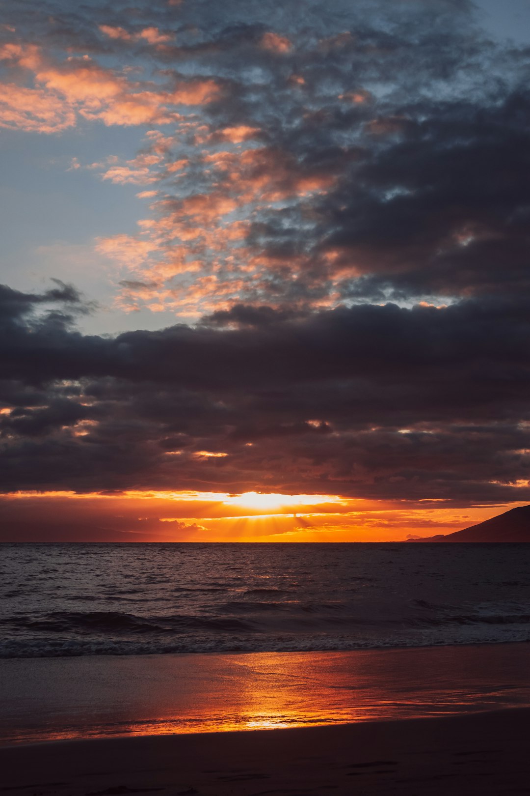 body of water under cloudy sky during sunset