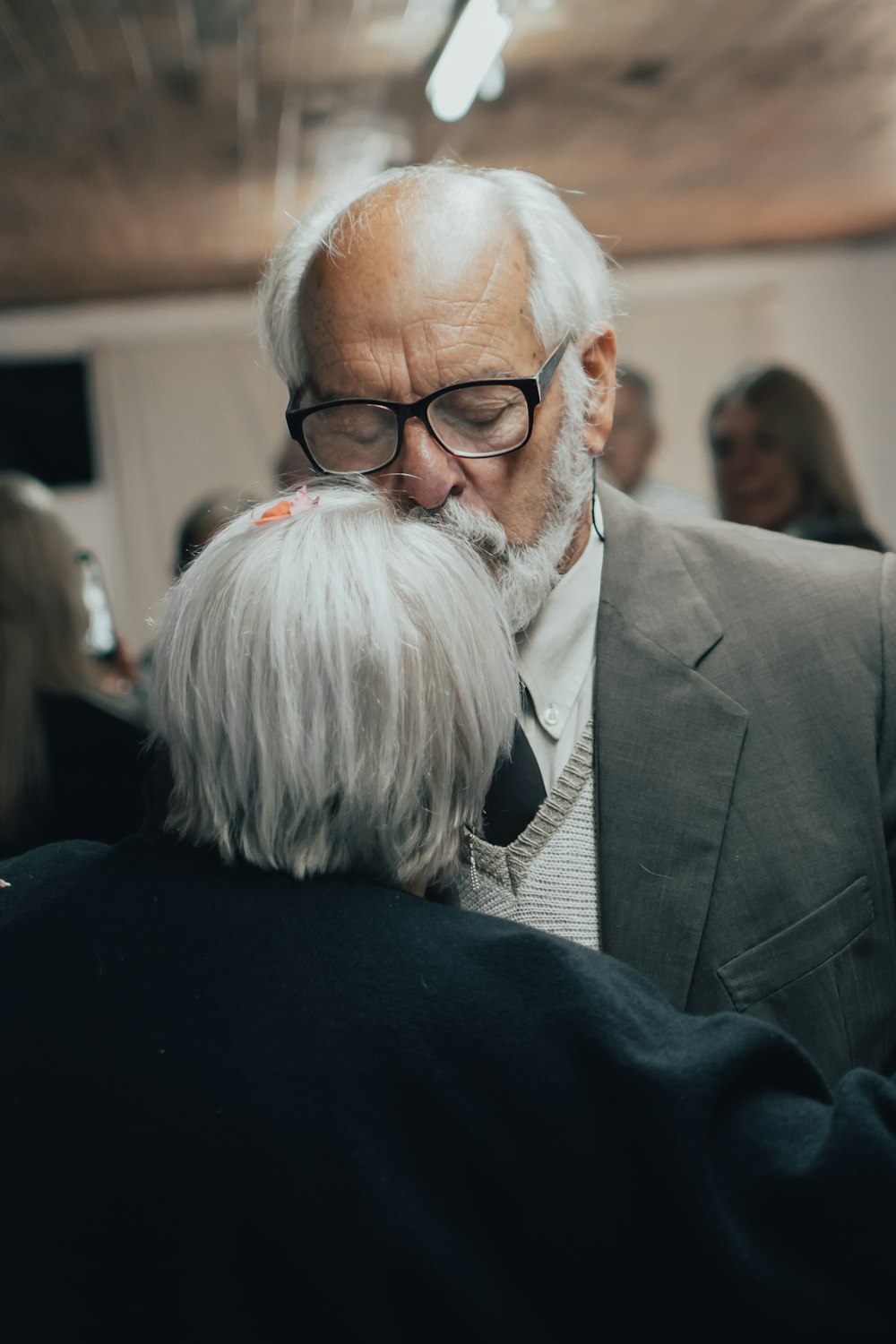 man in black suit jacket wearing eyeglasses