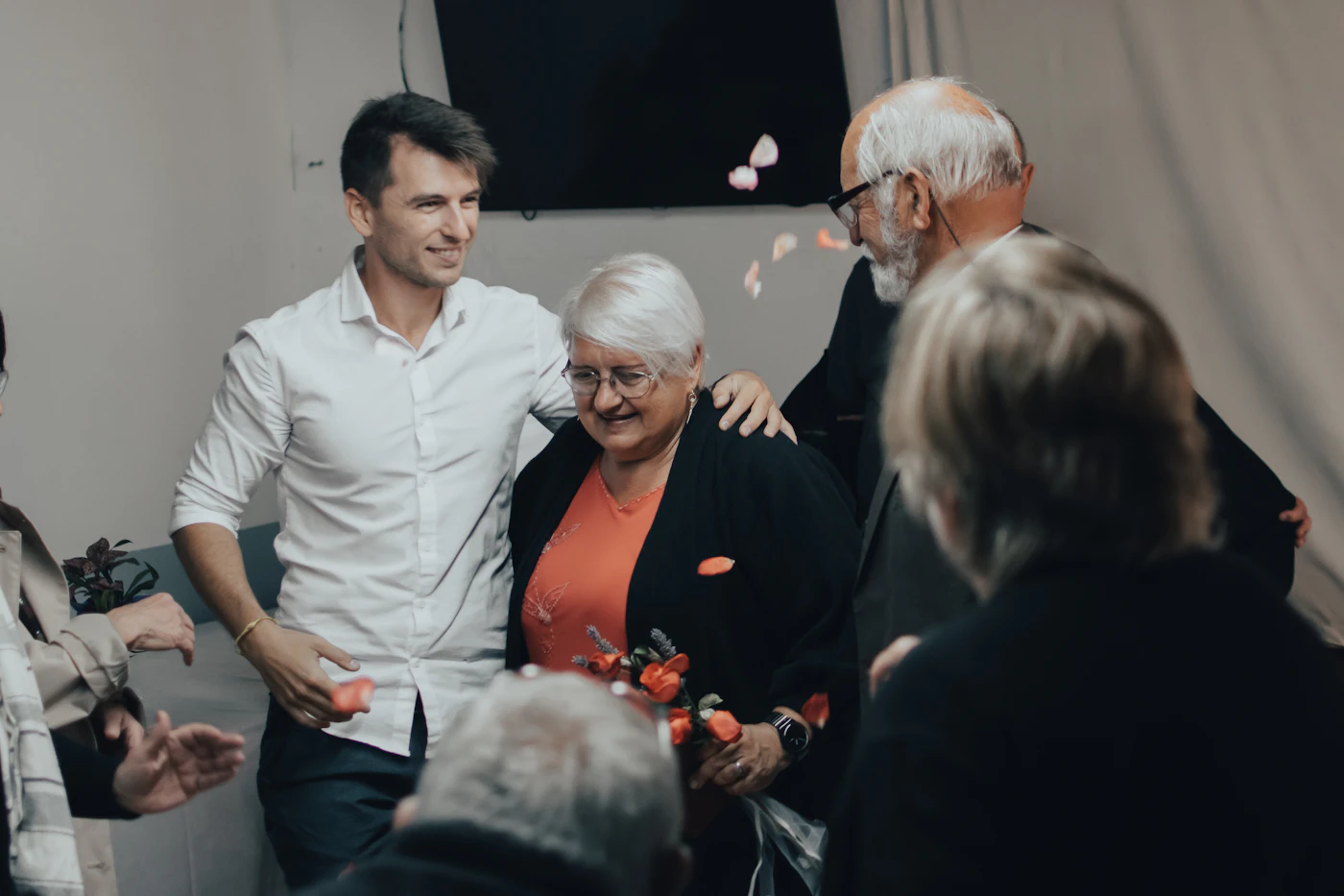 Older woman smiling with family members at home