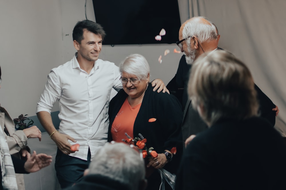 man in white dress shirt standing beside woman in black dress