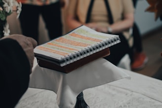 person holding black and white book