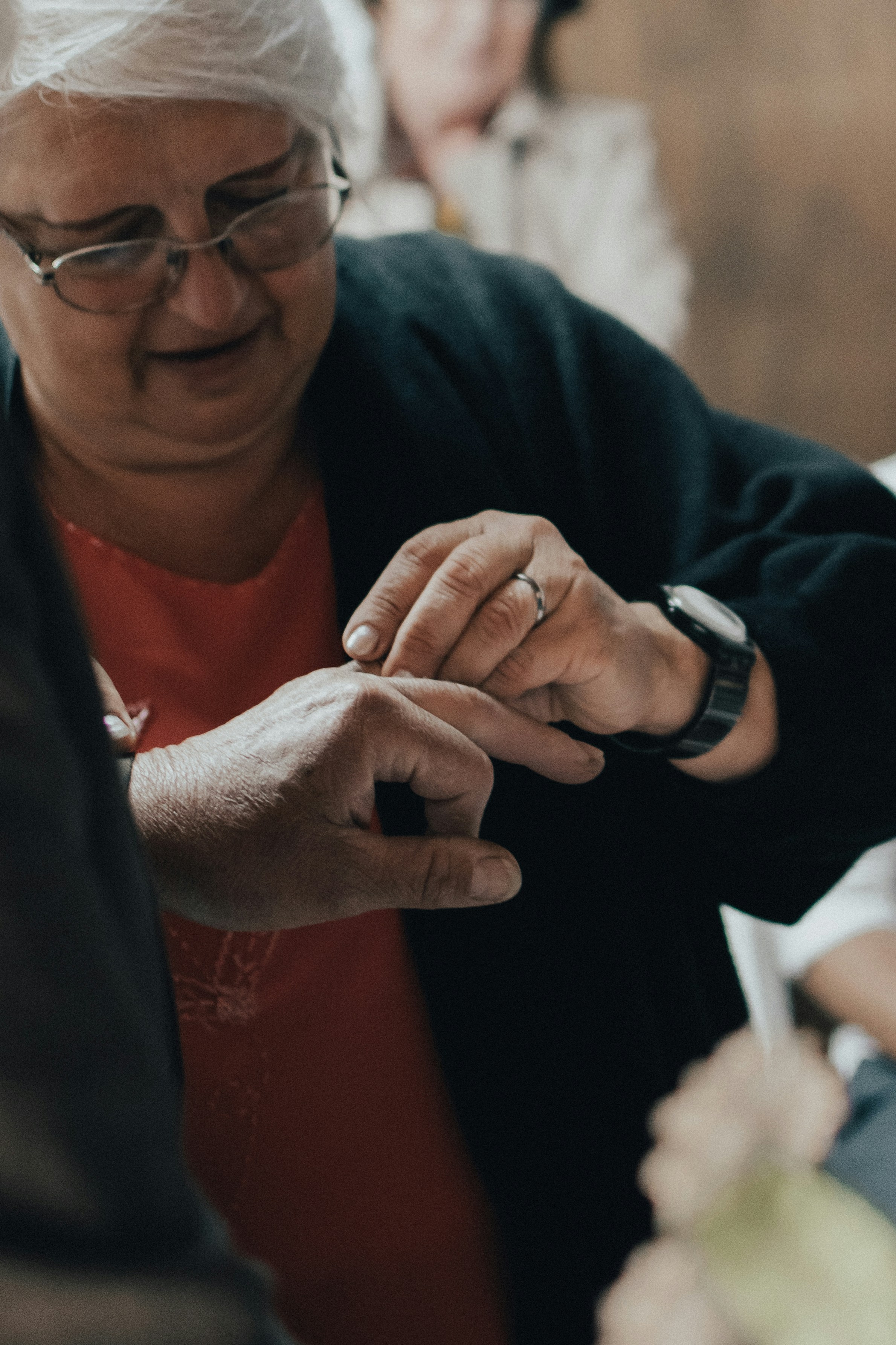 Person cleaning a watch with a soft cloth