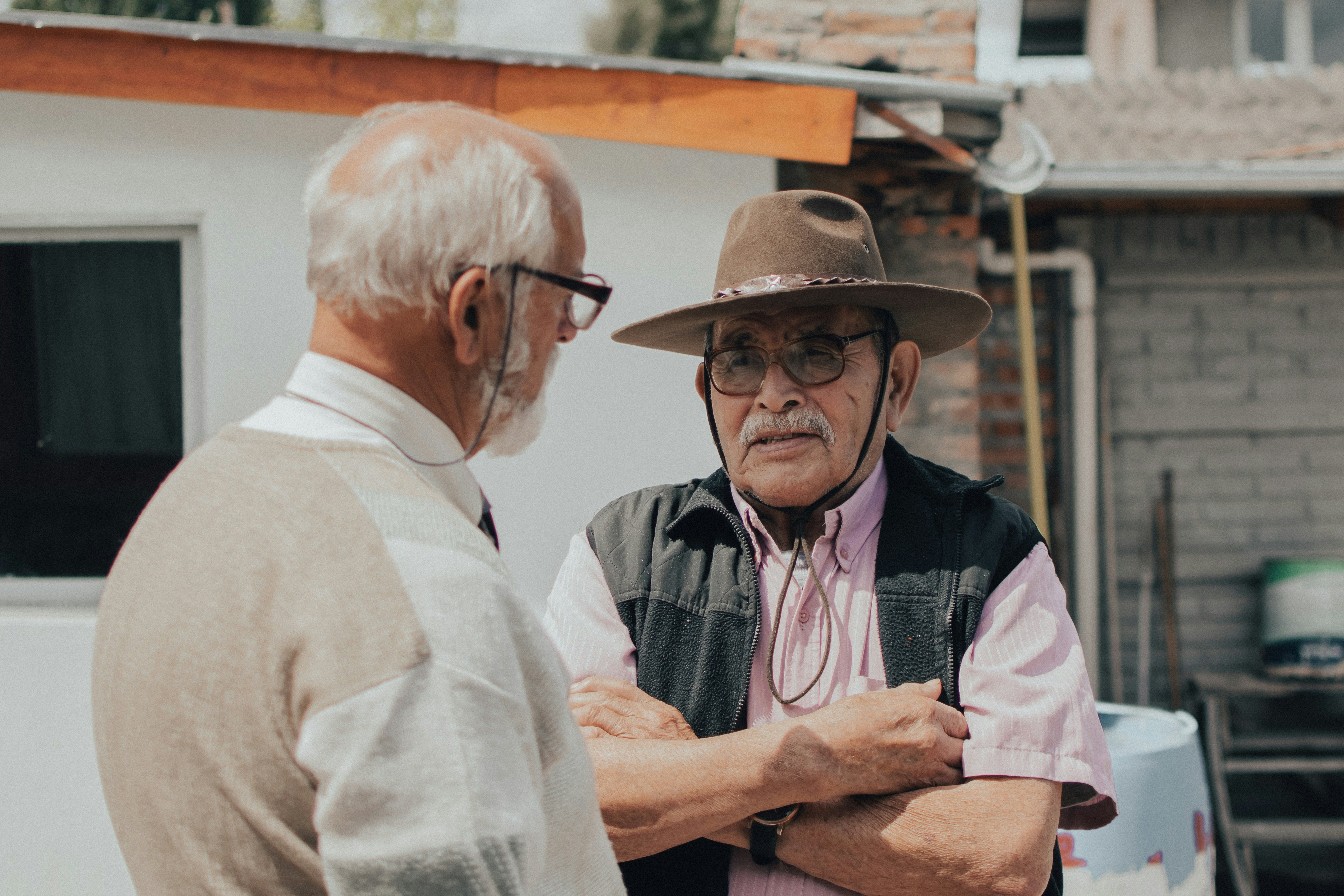 man in white button up shirt wearing brown hat
