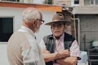 man in white button up shirt wearing brown hat