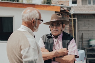 man in white button up shirt wearing brown hat