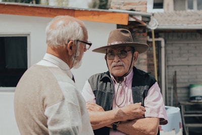 man in white button up shirt wearing brown hat