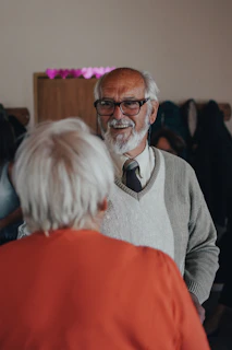 man in gray sweater wearing eyeglasses