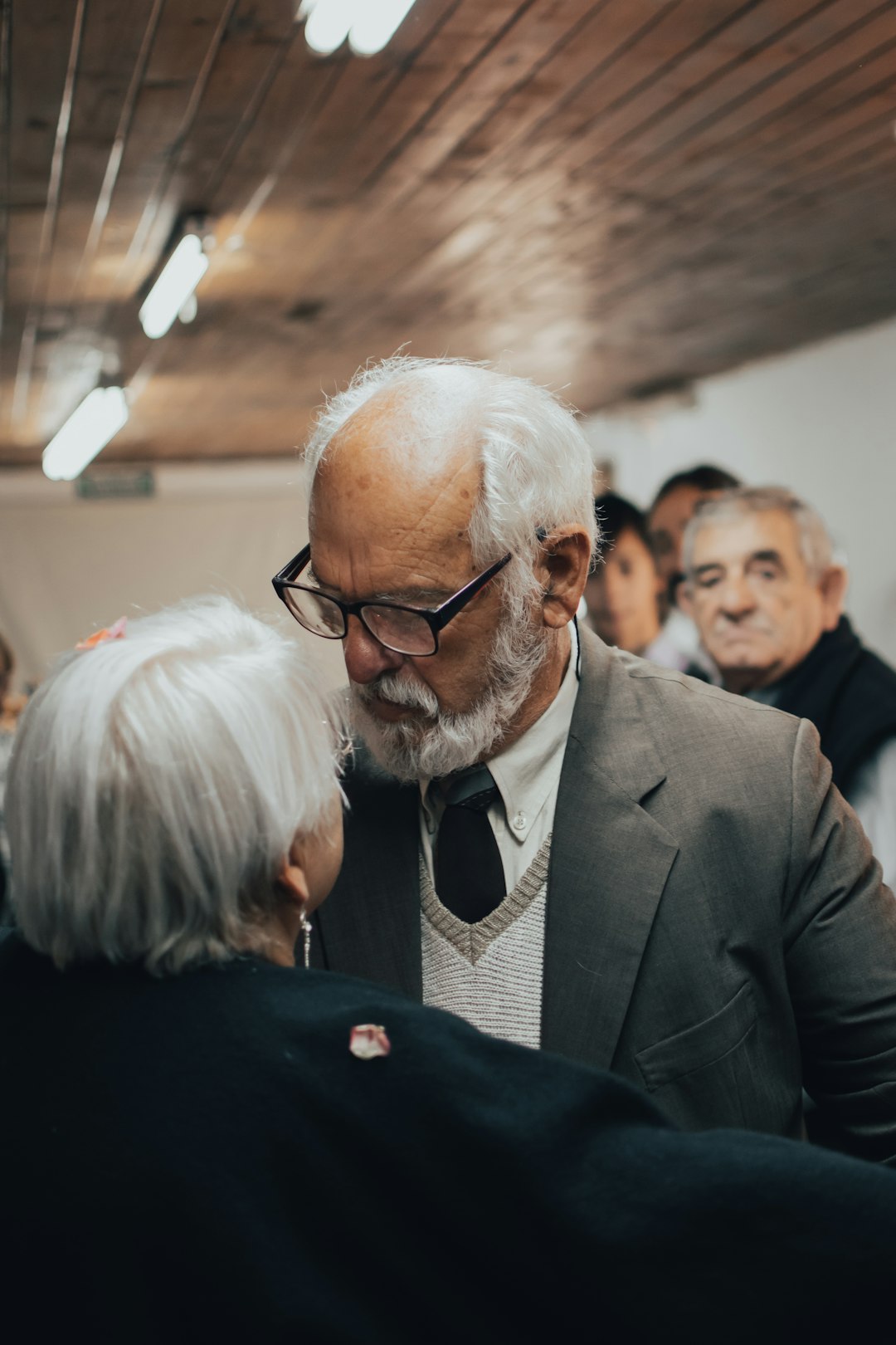 man in black suit jacket wearing black framed eyeglasses