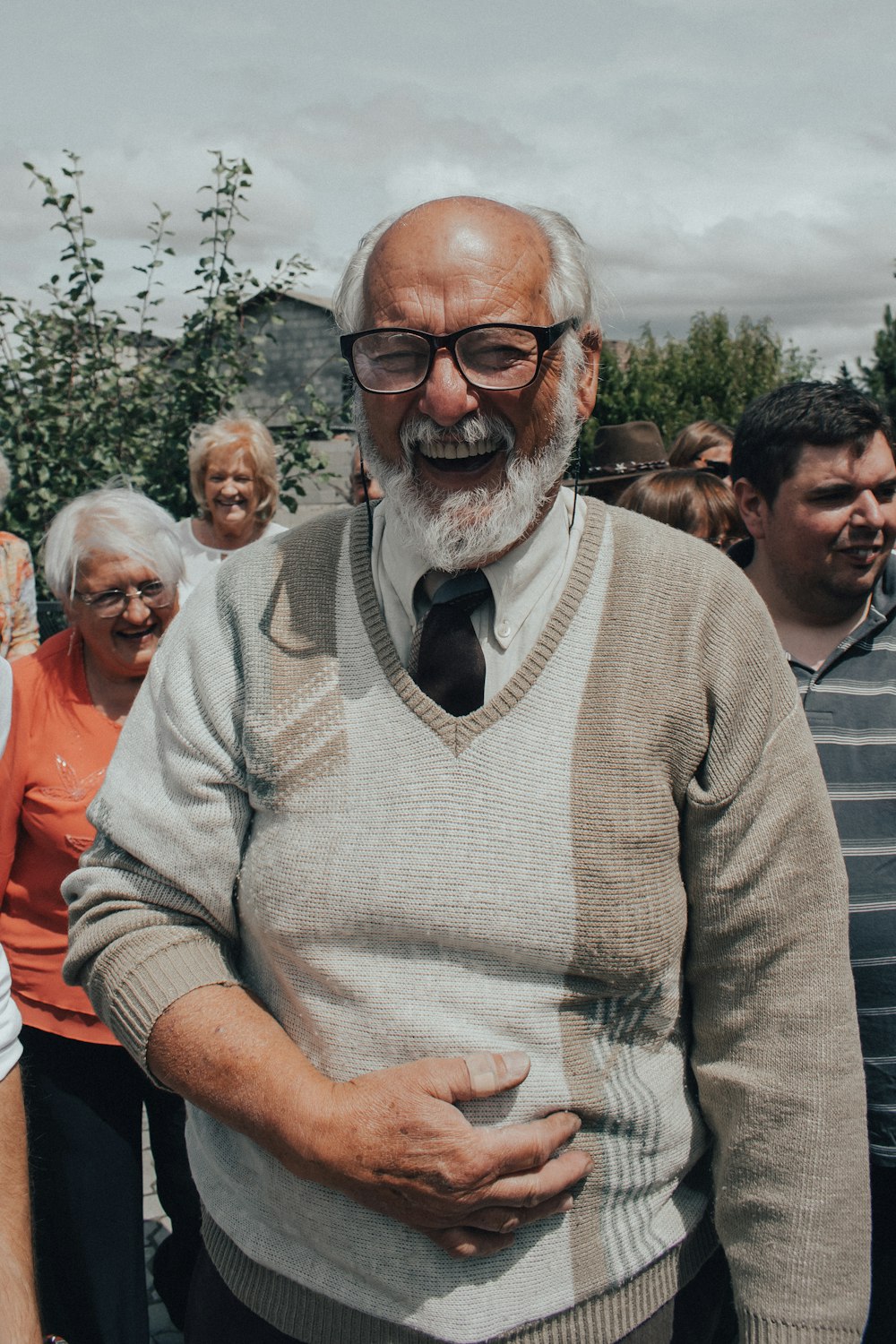 man in gray sweater wearing black framed eyeglasses