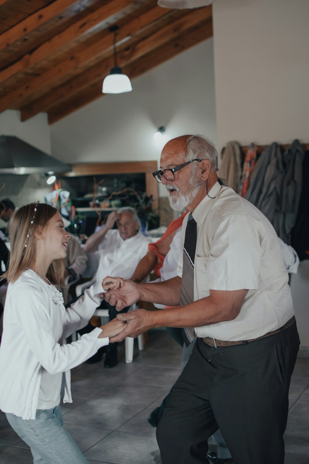 man in white button up shirt and black pants standing in front of woman in white