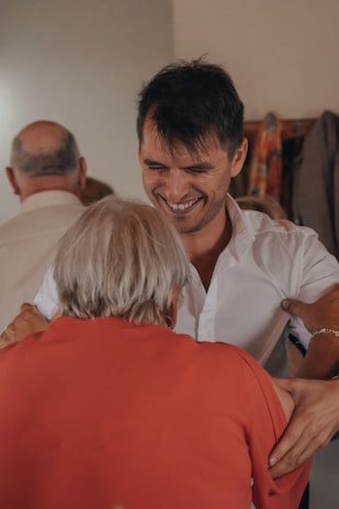 man in white dress shirt smiling beside woman in white dress shirt