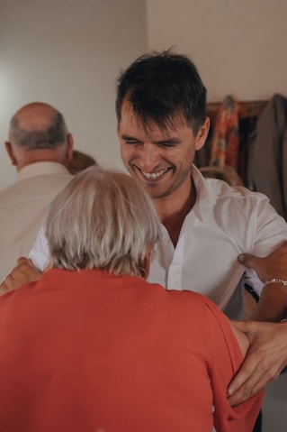 man in white dress shirt smiling beside woman in white dress shirt
