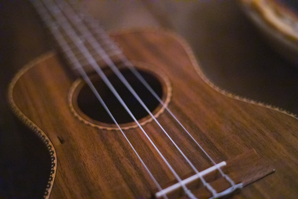 brown acoustic guitar in close up photography