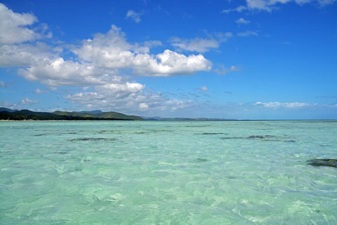 blue sea under blue sky and white clouds during daytime