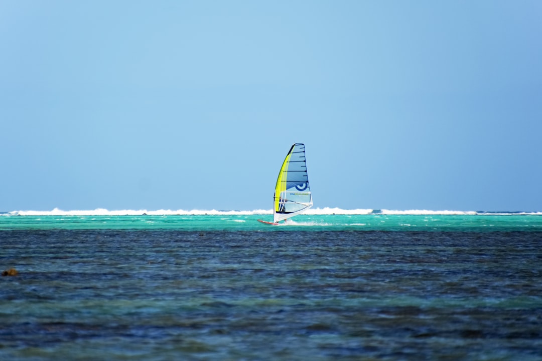 yellow and blue boat on sea during daytime