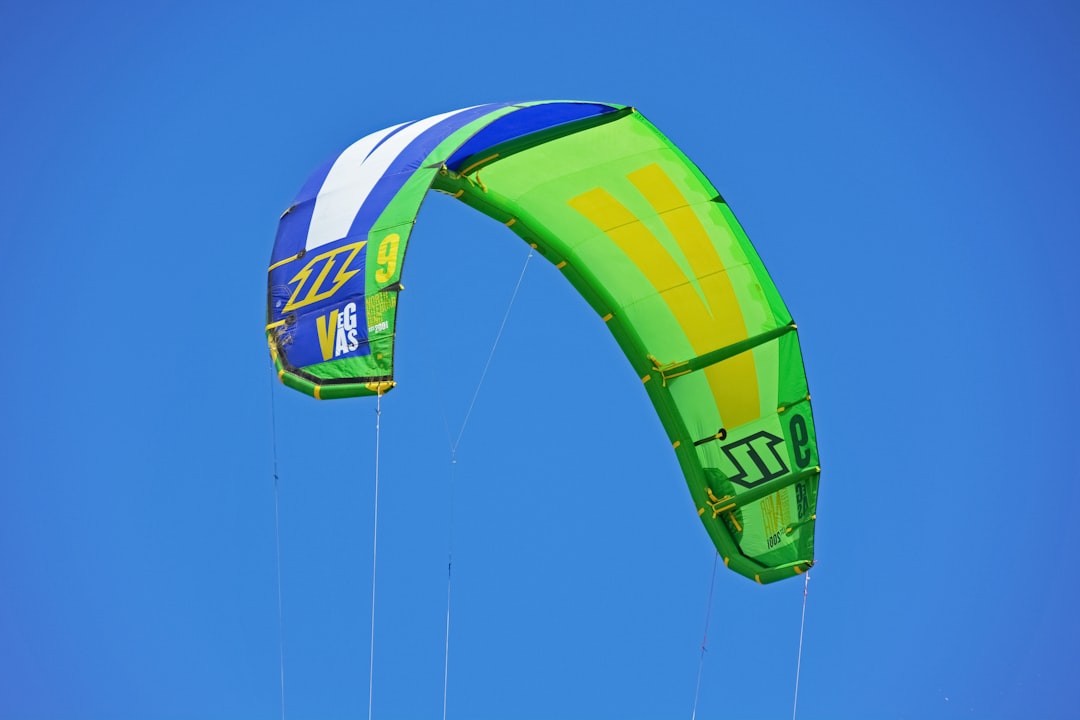 green blue and red kite flying under blue sky during daytime