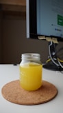 clear glass jar with yellow liquid inside