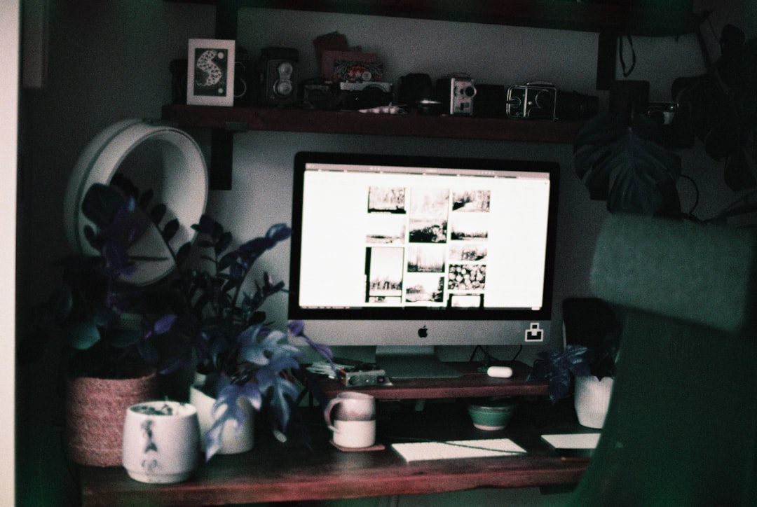 silver imac on brown wooden table