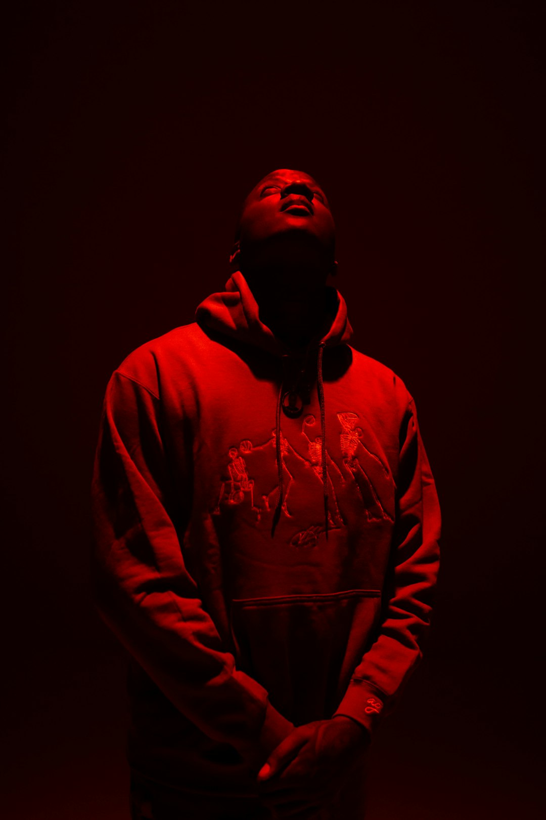 man in red hoodie standing