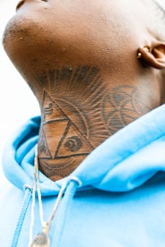 person with black and blue dragon tattoo