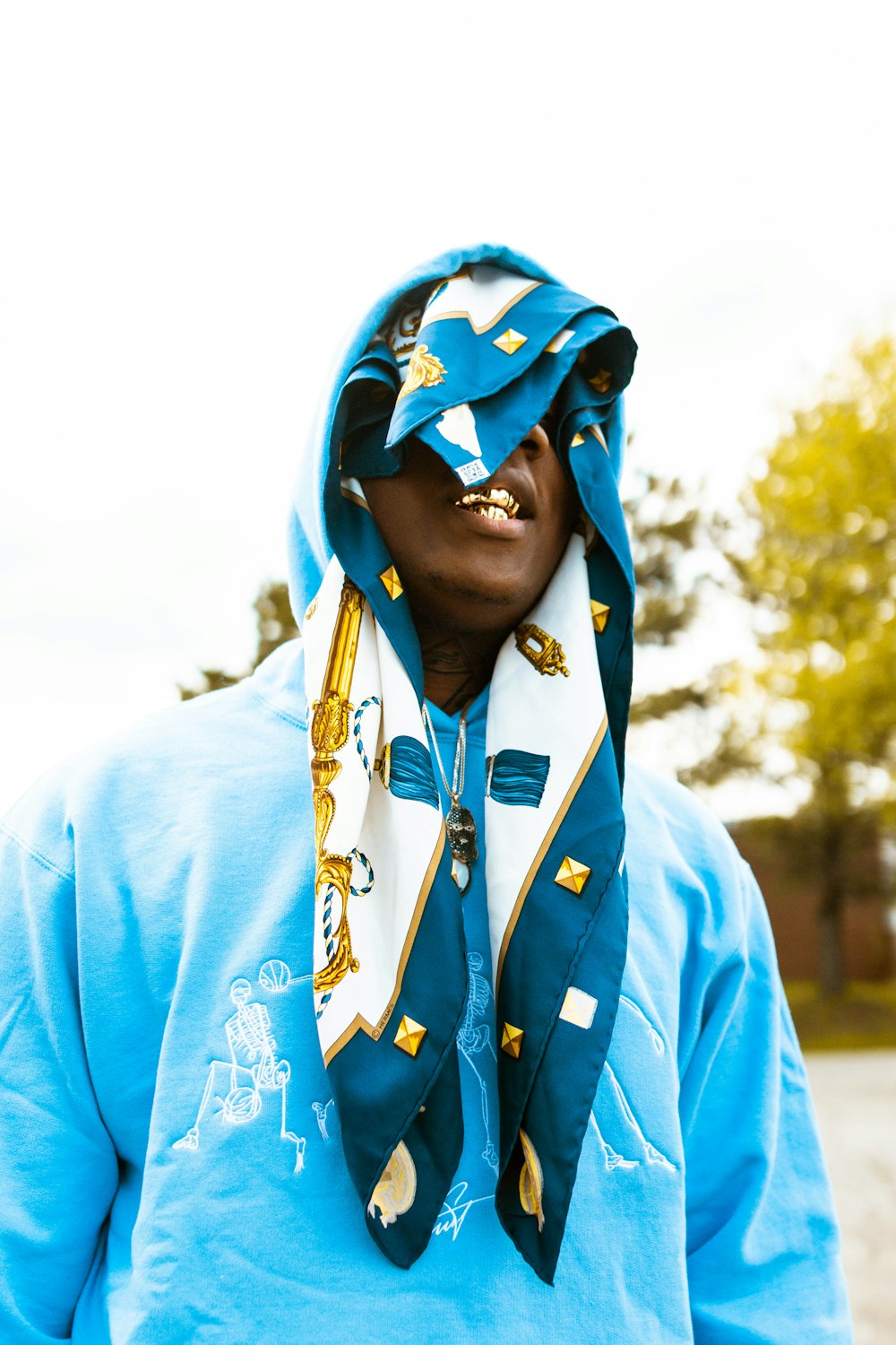 homme en sweat à capuche à fleurs bleu et jaune portant un masque à fleurs  bleu et blanc photo – Photo Vêtements Gratuite sur Unsplash