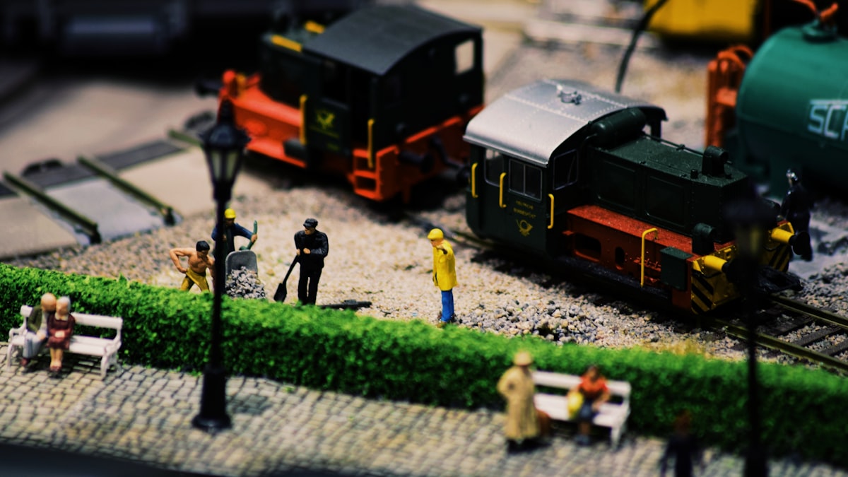 Miniatures on a model train layout painted with primer