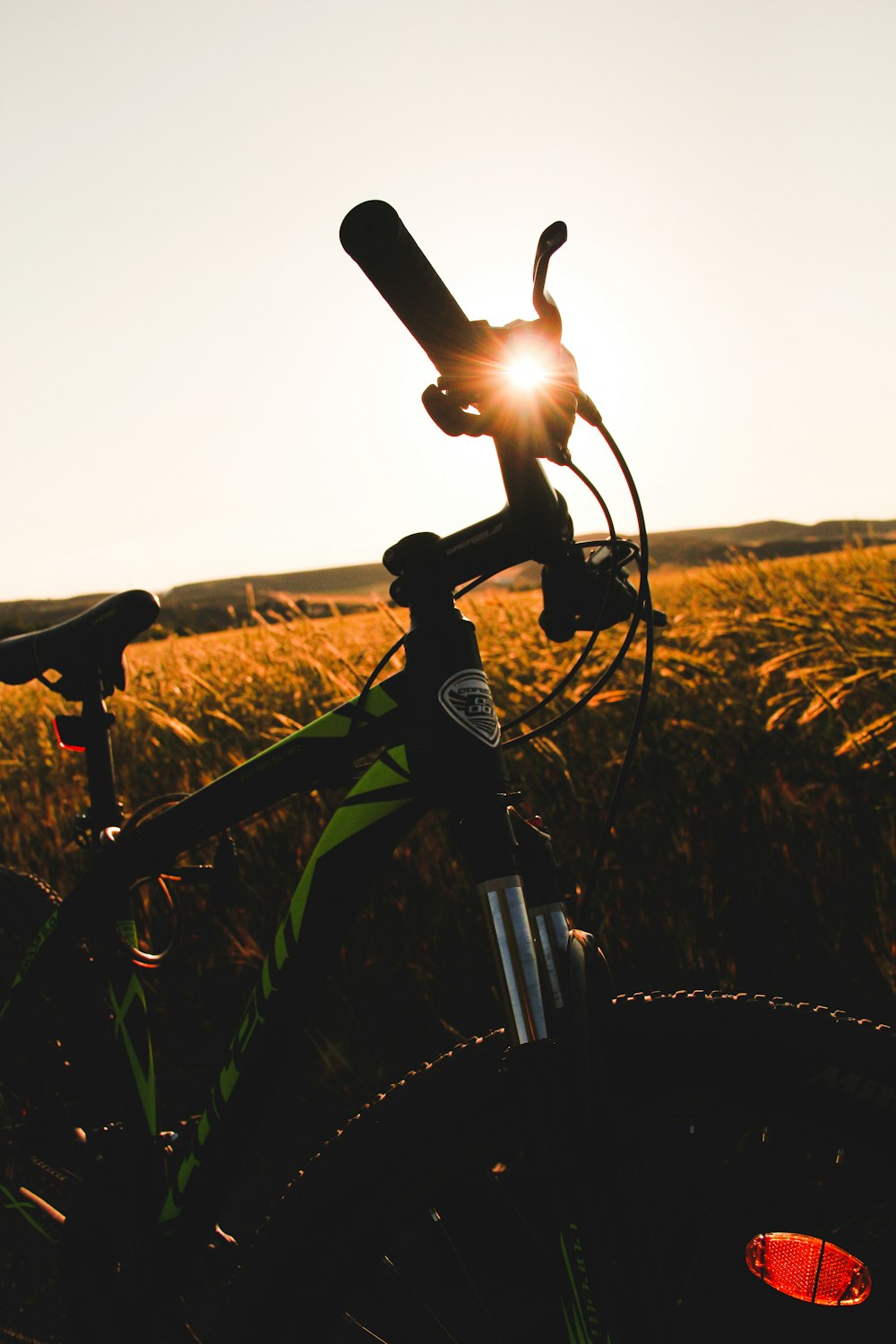 black bicycle on green grass field during daytime