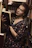 woman in black and red floral dress holding book