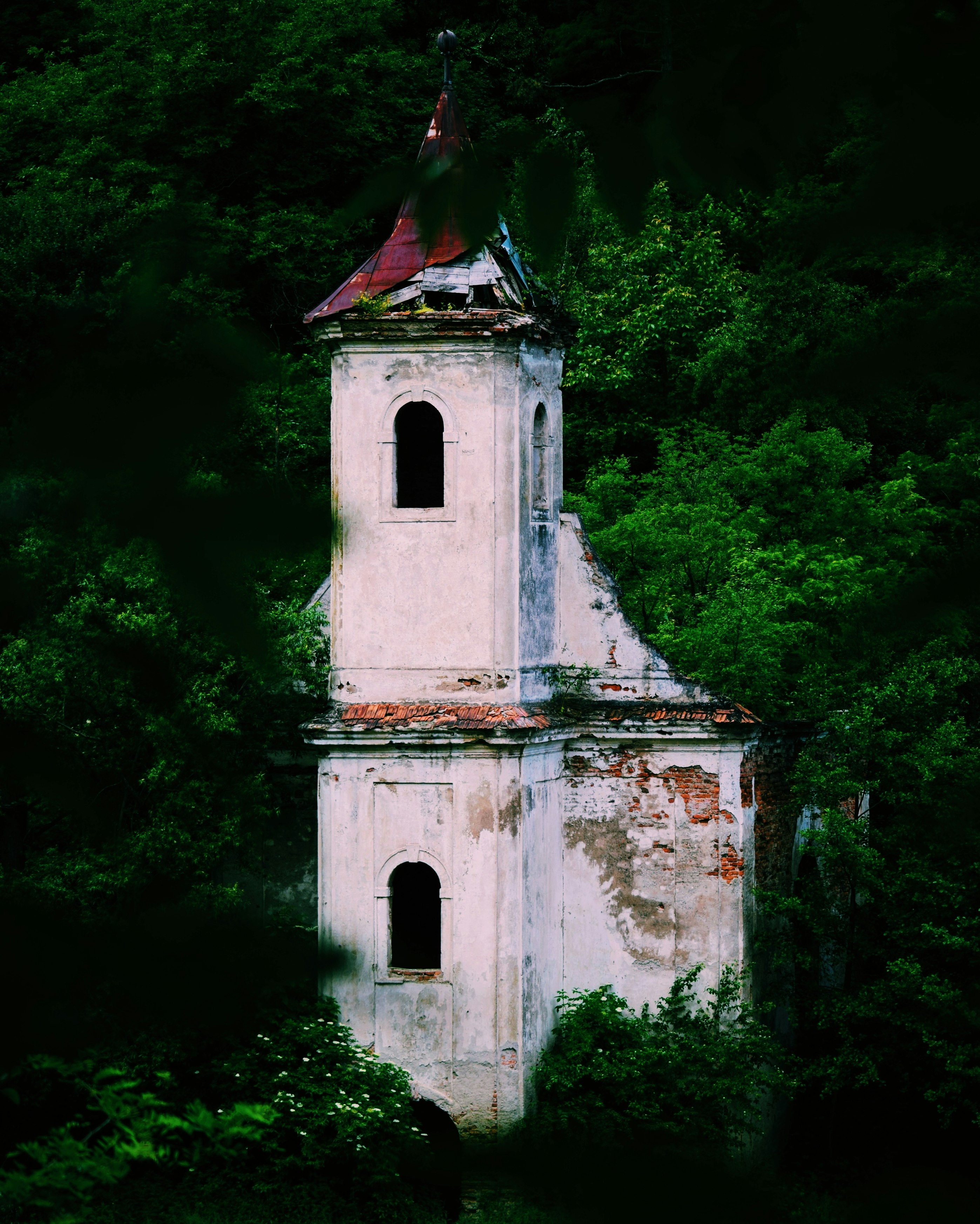 white concrete church near green trees during daytime