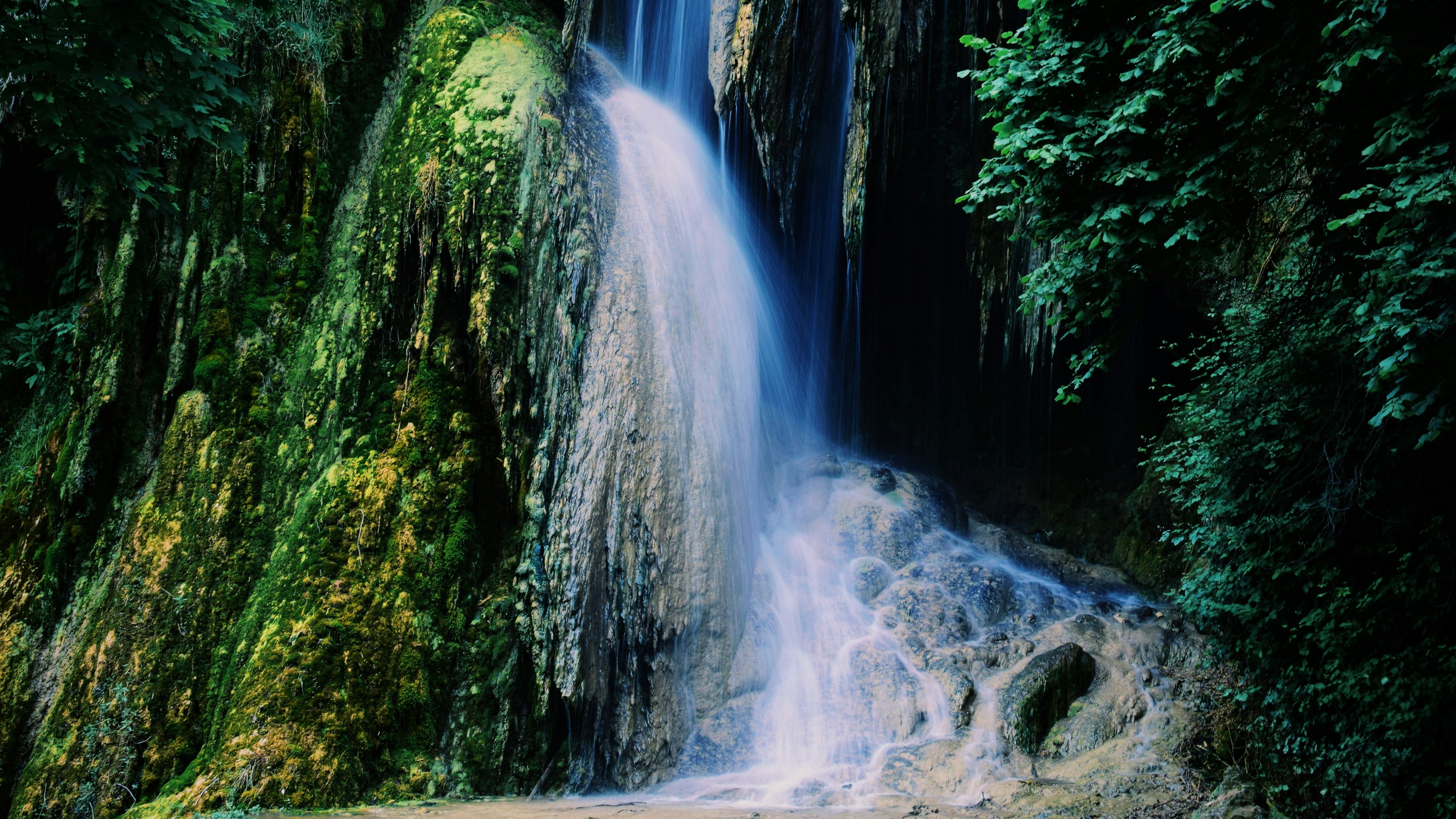 water falls in the middle of the forest