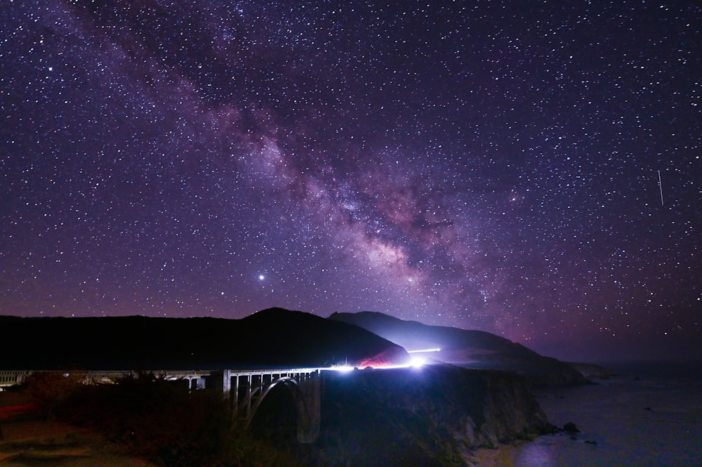 silhouette of mountain under starry night