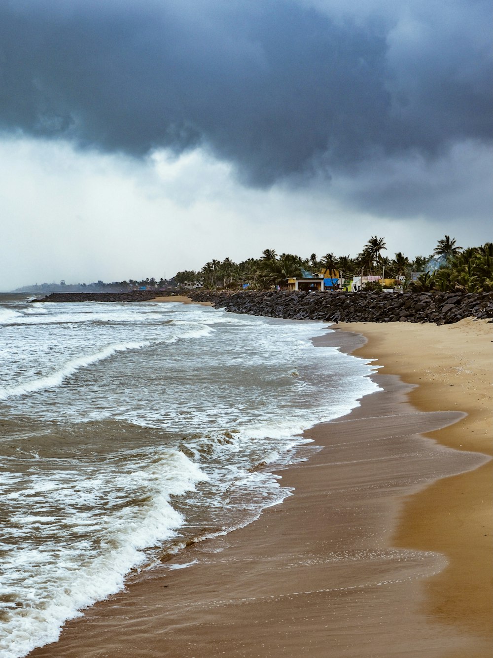 beach shore under cloudy sky during daytime