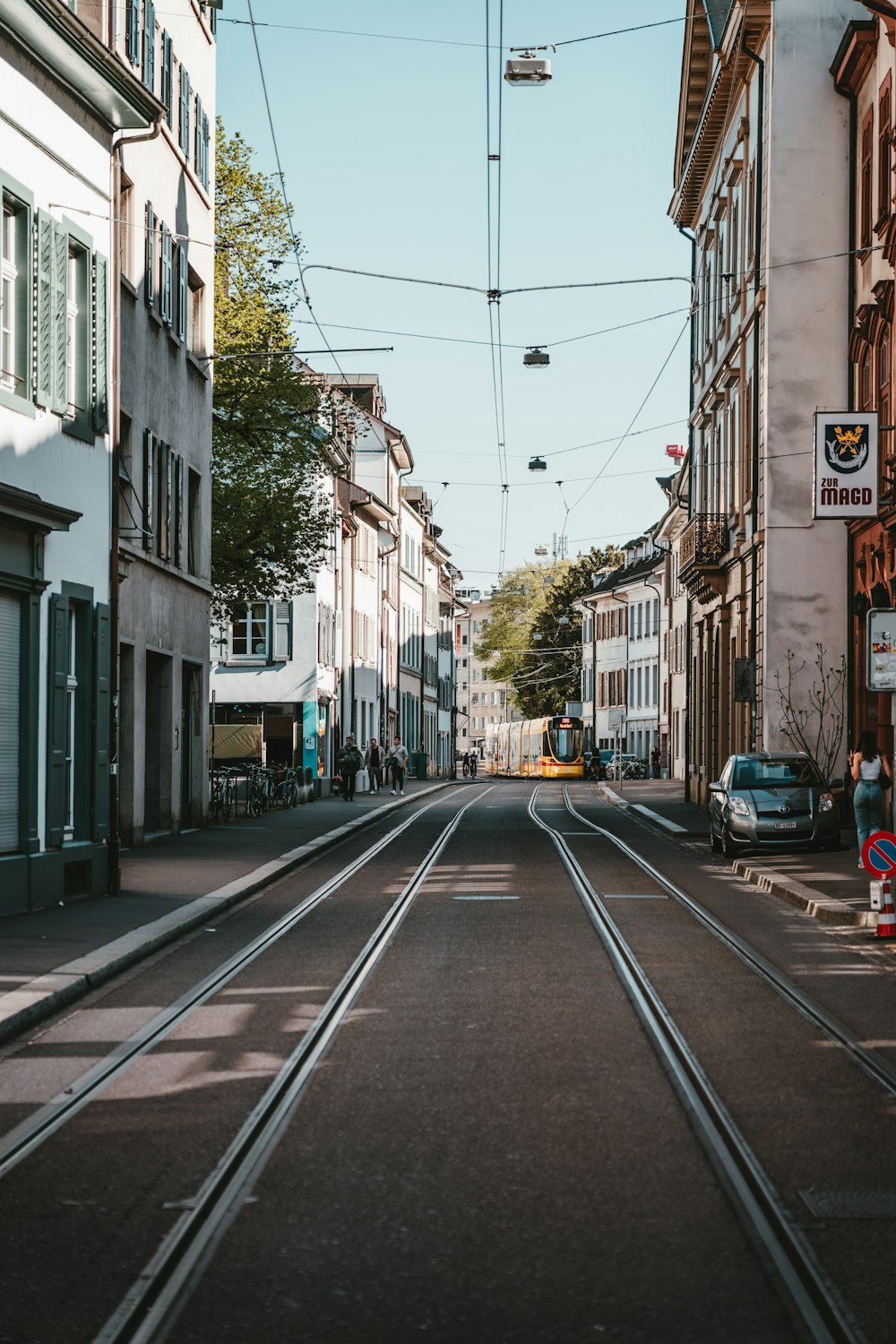 cars on road between buildings during daytime