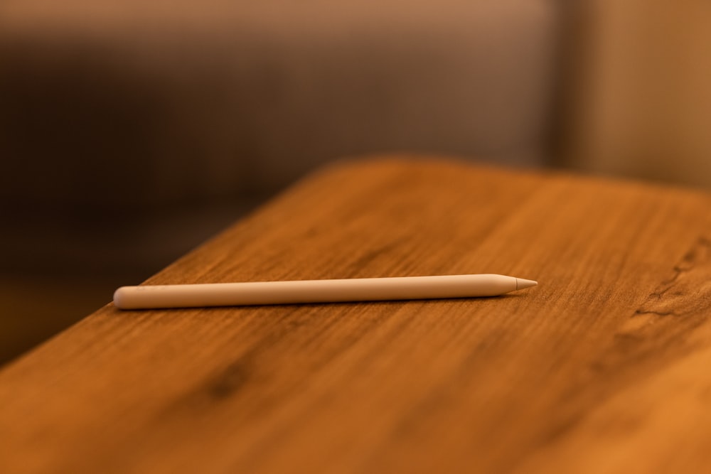 white pen on brown wooden table