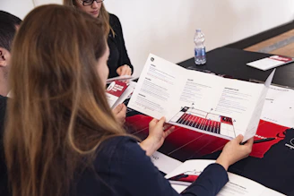 A close-up of young activists sharing ideas around a table with climate data charts.