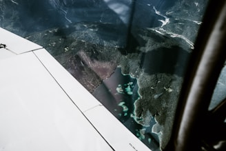 An aerial view of a jet cruising above the lush green islands of Indonesia.