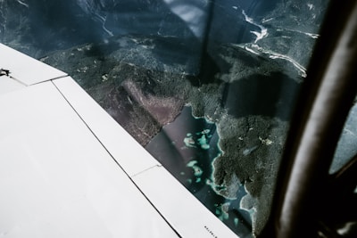 An aerial view of a jet cruising above the lush green islands of Indonesia.