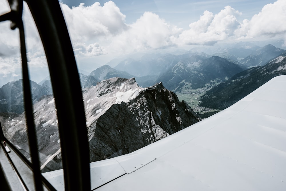 snow covered mountain under white clouds during daytime