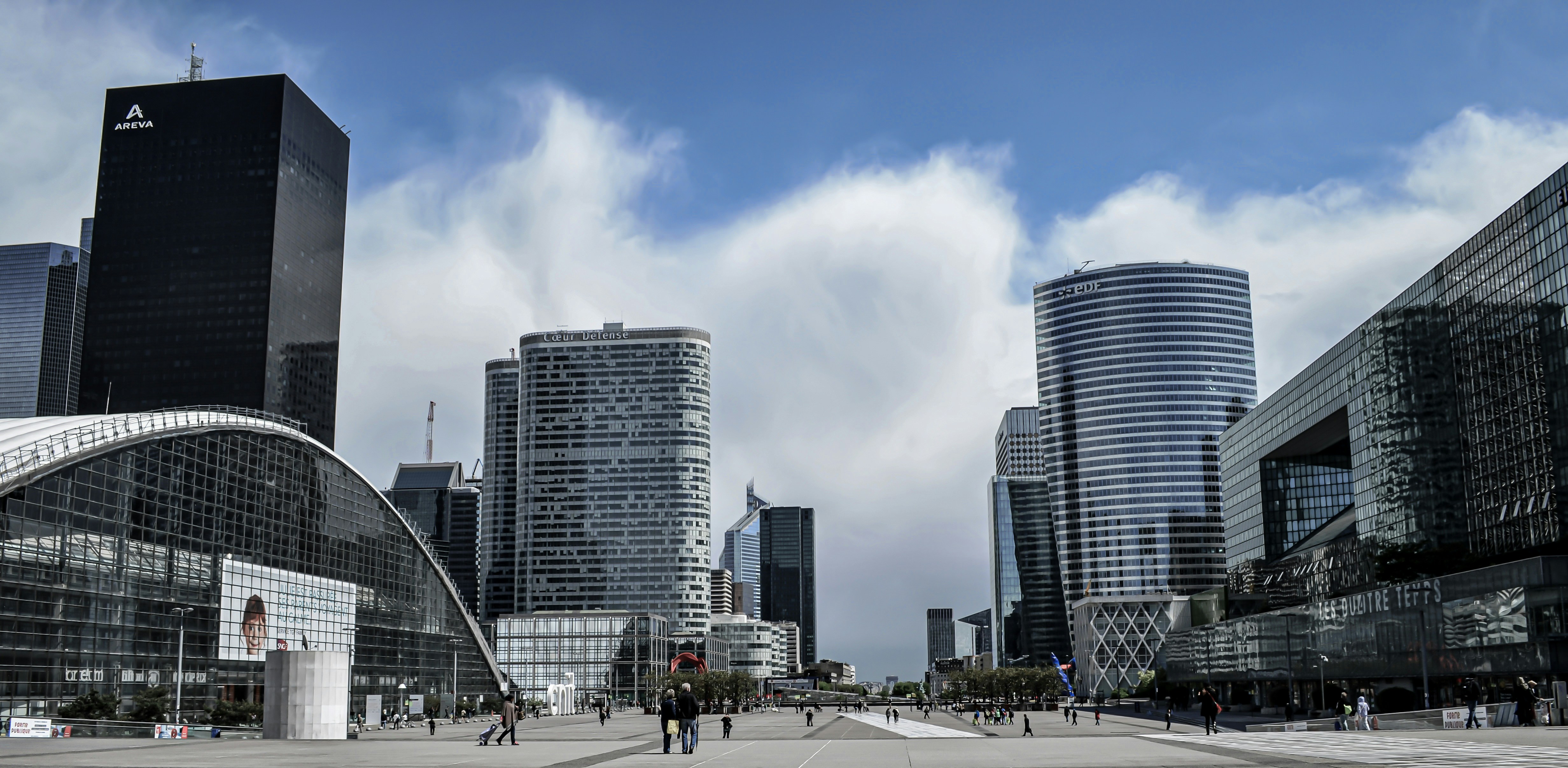 people walking on street near high rise buildings during daytime