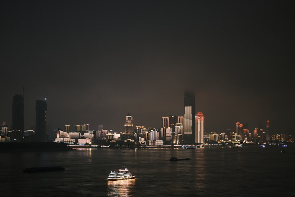 white and black boat on water during night time