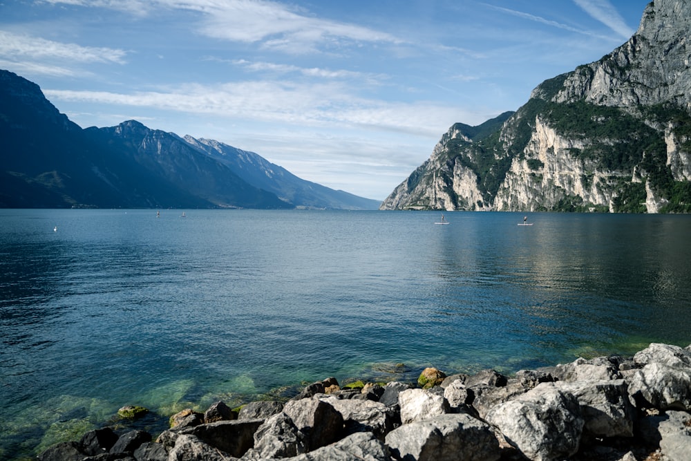 body of water near mountain during daytime