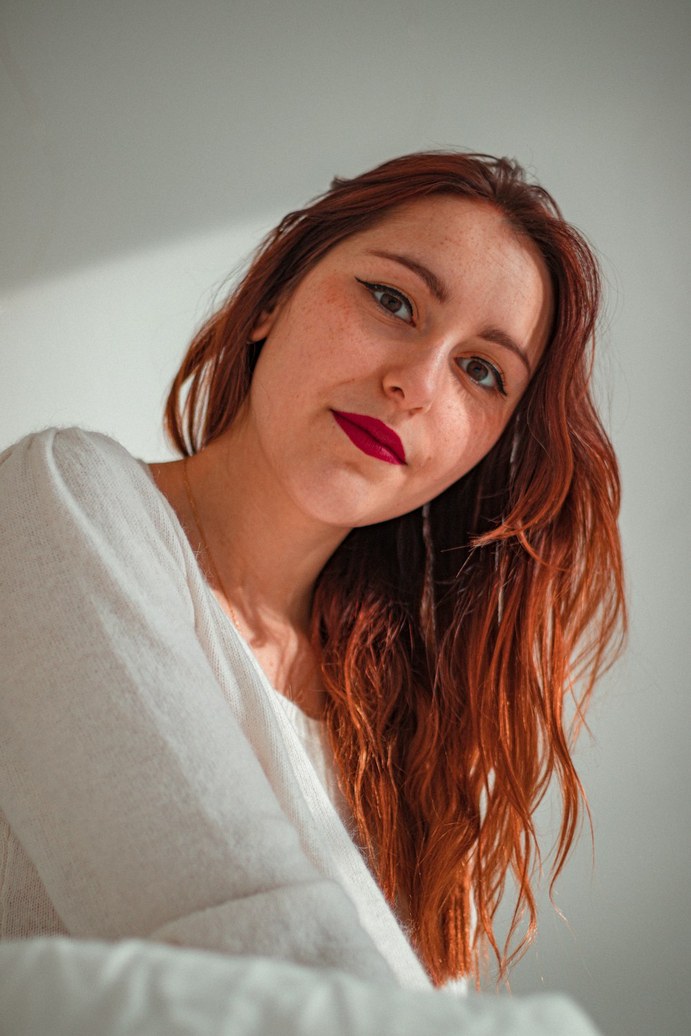 woman in white shirt with red hair