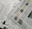 A section of a newspaper is placed over an open magazine. The newspaper displays a headline about the distribution of ex gratia finance and includes several smaller images and text flags. The magazine features articles and highlights, including historical and political content, with images and diagrams accompanying the text. The overall composition suggests a mix of current news and historical retrospectives.