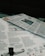 Newspapers and magazines are spread out, with text and images visible on the pages. One page has an article about historical topics, including a photo of an aircraft and a section discussing the inauguration of a political monument.