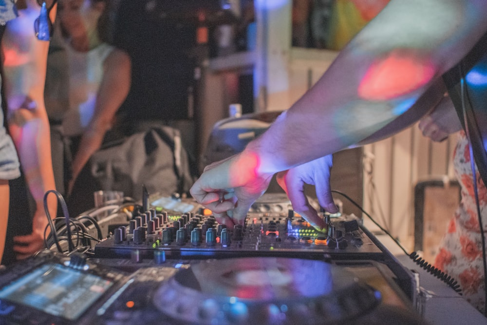 person playing audio mixer in room