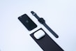 Close-up of sleek modern gadgets including headphones and smartwatches on a clean white surface.