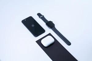 A sporty fitness tracker and car accessories arranged neatly on a clean black background
