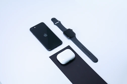 A sporty fitness tracker and car accessories arranged neatly on a clean black background