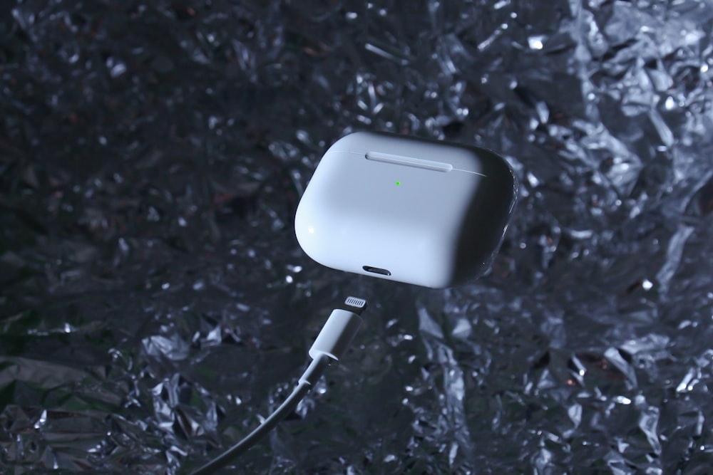 white charging adapter on black and gray surface