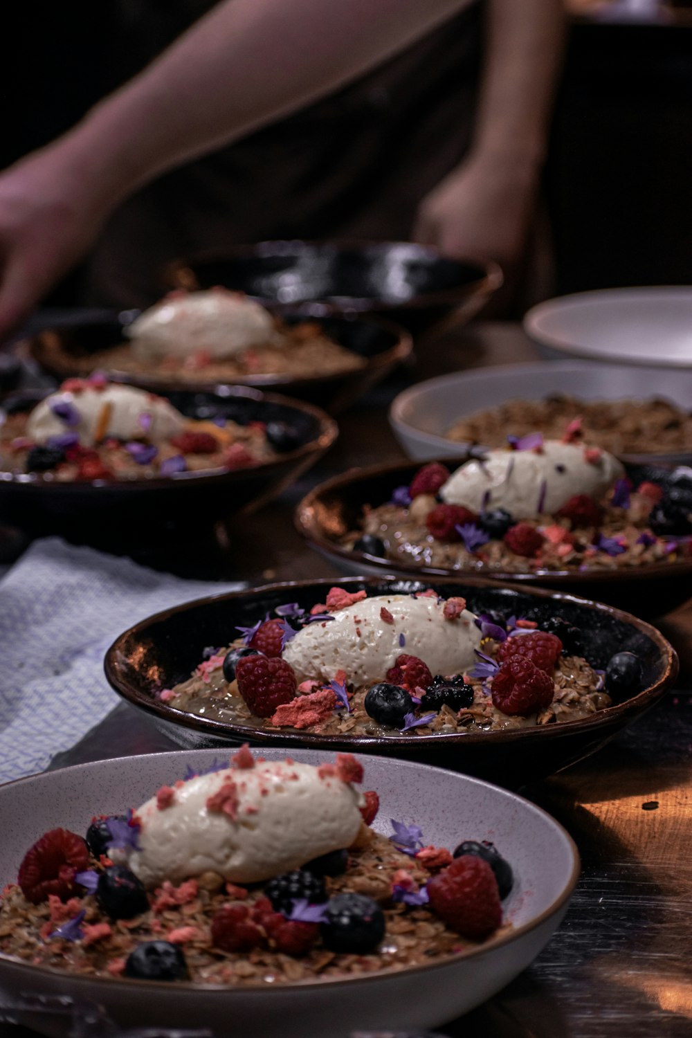 white and red floral food on black ceramic bowl